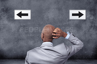 Buy stock photo Businessman, thinking and arrows with choice for direction, selection or pick on a gray studio background. Rear view of confused black man, or employee with pointing icons in wonder, thought or ideas