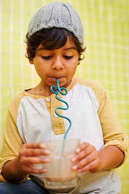 Buy stock photo Boy, milkshake and happy with drink, relax and smile with casual outfit and home with child development. Sweet, dessert and taste with delicious liquid and funky straw with glasses, calm and cool