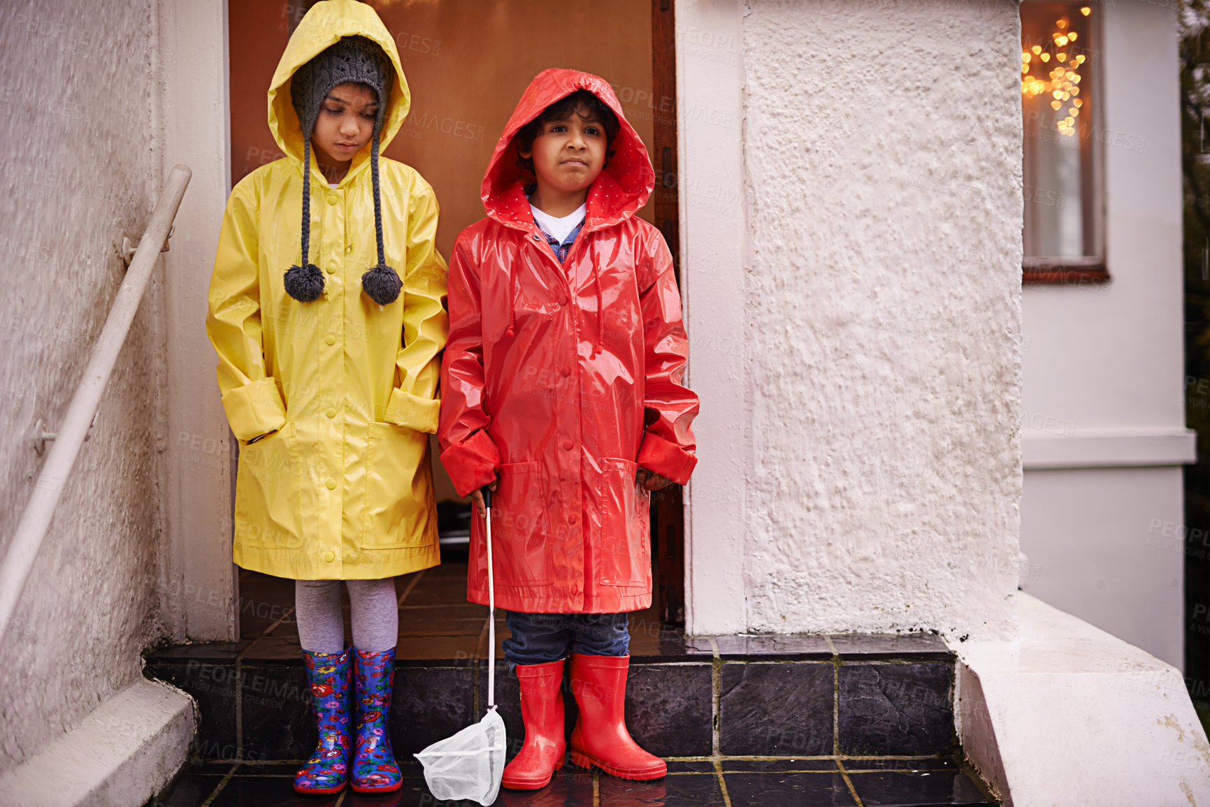 Buy stock photo Children, raincoat and portrait on porch for unhappy, cold weather and growing up for adolescent and innocent. Kids or child with boots and upset with sibling for storm and season for holiday 