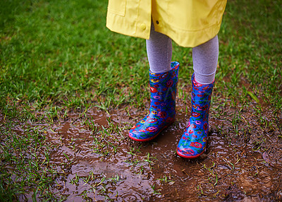 Buy stock photo Soil, feet and boots of kid playing in rain for forest, adventure or fun explore games in nature closeup. Earth, mud and shoes of child in woods for walking, camping or travel, holiday or vacation