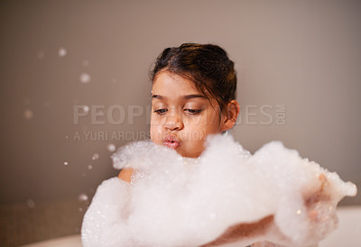 Buy stock photo Bath, blowing bubbles or girl with soap in a house for body care, washing or cleaning. Bathtub, face and playful kid in bathroom with wellness skincare cosmetics, hygiene or fun with water splash