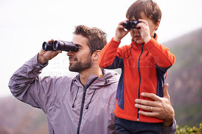 Buy stock photo Dad, kid and binoculars with smile from hiking, travel and watching in nature with adventure. Parent, youth and father with love, support and trust outdoor with family with view on trip with walking