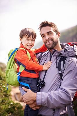Buy stock photo Father, child and hiking portrait with smile, backpack and travel with happy and support in nature. Kid, adventure and mountain with love, trust and bonding with family and journey for holiday