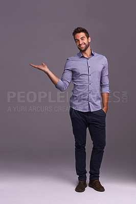 Buy stock photo Happy man, portrait and advertising with palm for marketing, presentation or showcase on a gray studio background. Young and handsome male person or employee with smile showing option on mockup space