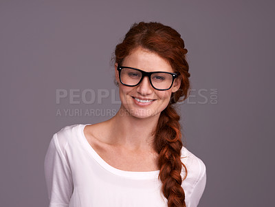 Buy stock photo Studio shot of an attractive young redheaded woman against a grey background