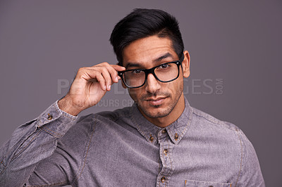 Buy stock photo Young man, face and glasses in studio for eye care, vision and new frame with confidence on a gray background. Portrait of a young person or cool model in spectacles, eyewear and vision or lens check