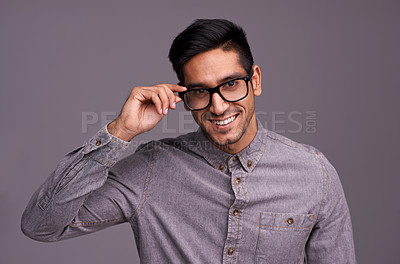 Buy stock photo Happy man, face and glasses in studio for eye care, vision and new frame with confidence on a gray background. Portrait of a young person or cool model in spectacles, eyewear and test for lens check