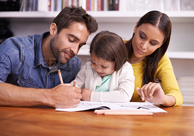 Buy stock photo Mom, dad and child at table with homework for teaching, learning and support in education with love. Writing, drawing and parents with little daughter for help in homeschool, growth and development