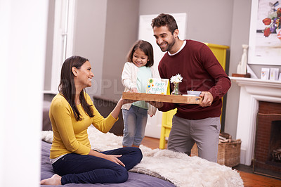 Buy stock photo A man and his daughter bringing his wife breakfast in bed on Mother's day
