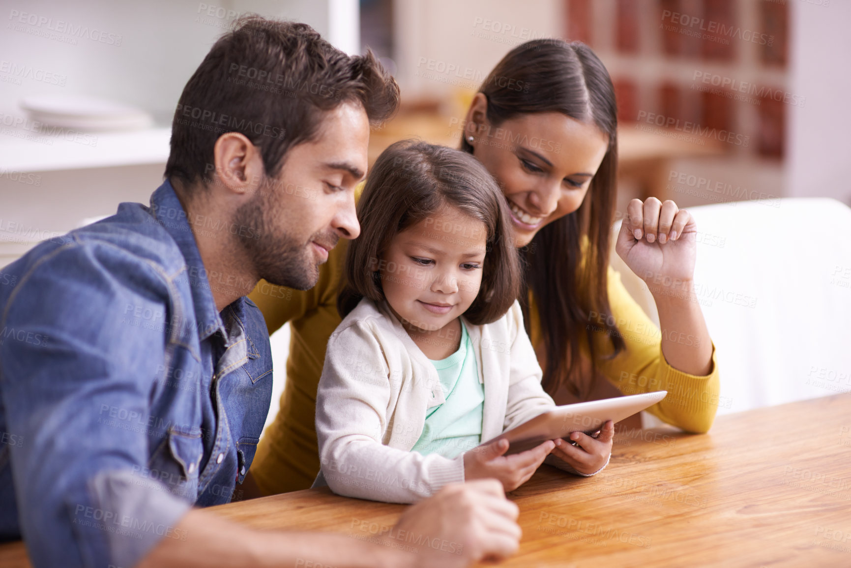 Buy stock photo Mom, dad and kid with tablet for teaching, learning and support in education with love at table. Elearning, digital app and parents with girl for help in homeschool, growth and development online