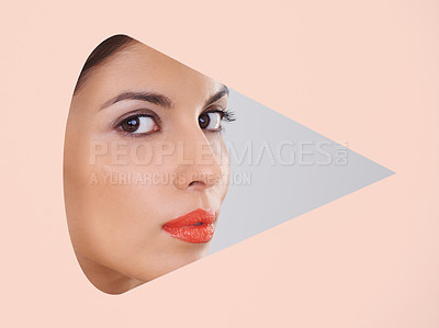 Buy stock photo Shot of a beautiful young woman through a cut out shape