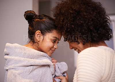 Buy stock photo Mother, child in bath towel and close for love, bonding and hugging after cleaning, shower and routine in a bathroom. Washing, embrace and mom with girl, loving and care after a bath in their home