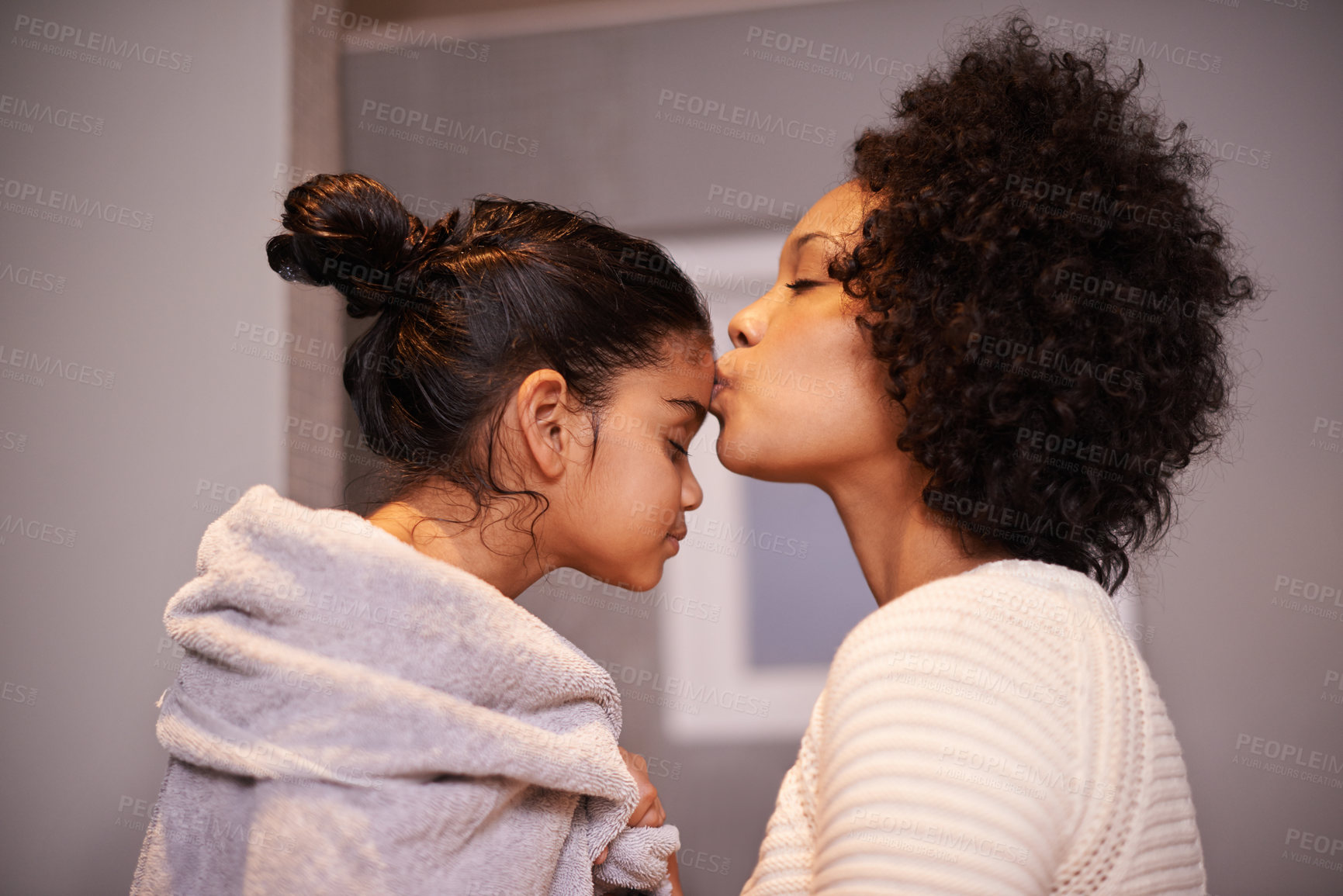Buy stock photo Love, kiss and mother with girl in a bathroom for cleaning, bonding and bonding after shower routine. Washing, towel and mom kissing forehead of child after bath, sweet and caring in their home 