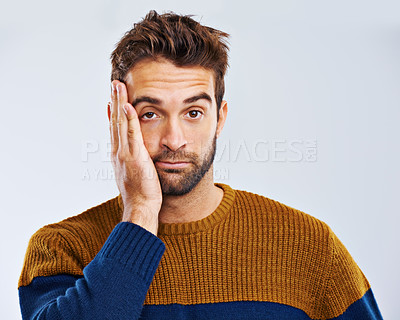 Buy stock photo Bored man, portrait and headache with stress, depression or anxiety on a white studio background. Young guy, tired model or upset male person in mistake, disappointed or mental health on mockup space