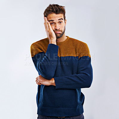Buy stock photo Frustrated man, portrait and bored with headache in stress, depression or anxiety on a studio background. Young, tired or upset male person with mood, disappointed or mental health on mockup space