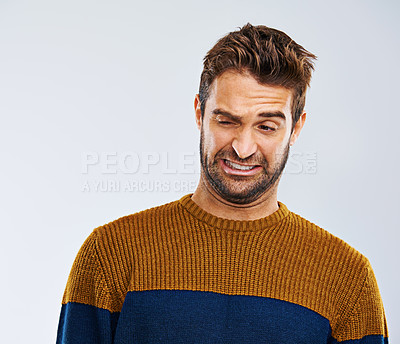Buy stock photo Man, face and problem with disgust in studio for dirty hygiene, smelling odor and negative body language. Person, shame or regret on white background for halitosis or upset expression on mockup space