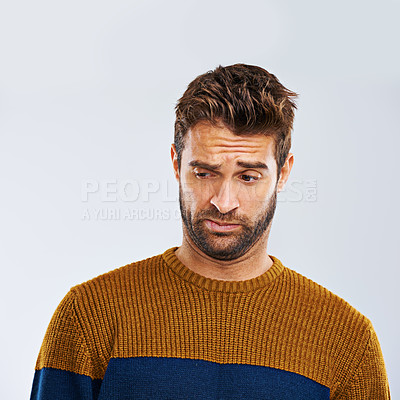 Buy stock photo Man, frown and facial expression in studio for disgust and regret for attitude, emotion and mood. Male model and  young person and alone with face gesture for grimace and annoyed on white background