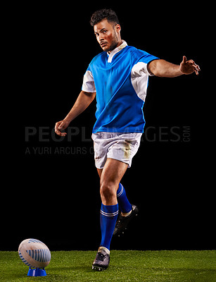 Buy stock photo Kick, ball and portrait of man for rugby sport or training for workout, fitness and skill. Person or player on grass and athlete practice for goal or football game or match on black background.