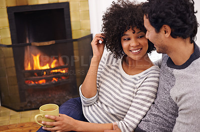 Buy stock photo Couple, fireplace and relax for care and home for peace, smile and proud of marriage and commitment. Happy people, coffee and date on floor in lounge on weekend, support and trust in relationship