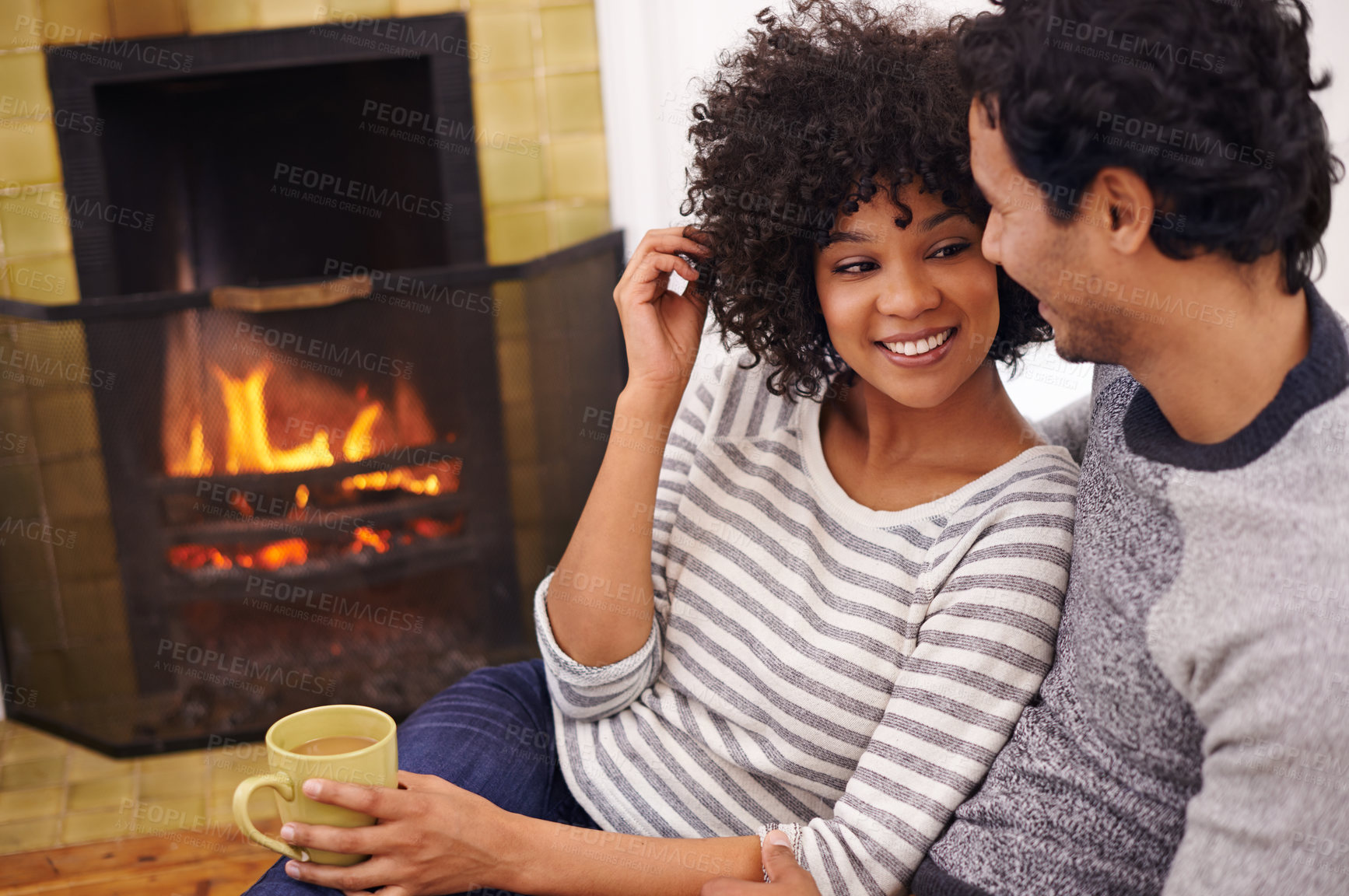 Buy stock photo Couple, fireplace and relax for care and home for peace, smile and proud of marriage and commitment. Happy people, coffee and date on floor in lounge on weekend, support and trust in relationship