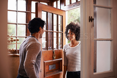 Buy stock photo Cropped shot of a young man greeting his wife at the door