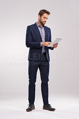 Buy stock photo Businessman, confident and tablet for internet in studio on white background for startup company as salesman. Corporate, entrepreneur and browse online or website to network, search for opportunity