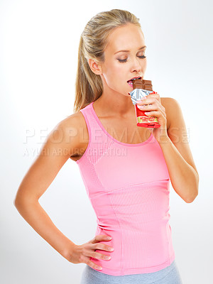 Buy stock photo Woman, studio and wellness with dessert, health and eating chocolate for diet. Antioxidants, cocoa in candy bar or nutritional benefits, hungry sports instructor or fitness for carbs or female person