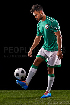 Buy stock photo Man, ball and soccer for sport, balance and fitness for game, active and sportswear on grass or field. Role model, athlete or player and practice for kick, competitive and score  on dark background

