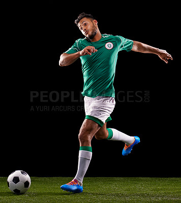 Buy stock photo Man, ball and soccer for sport and fitness for game, active and sportswear on grass or field. Role model, athlete or player and practice for kick, competitive and score in night on dark background