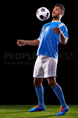 Buy stock photo Full length studio shot of a handsome young soccer player isolated on black