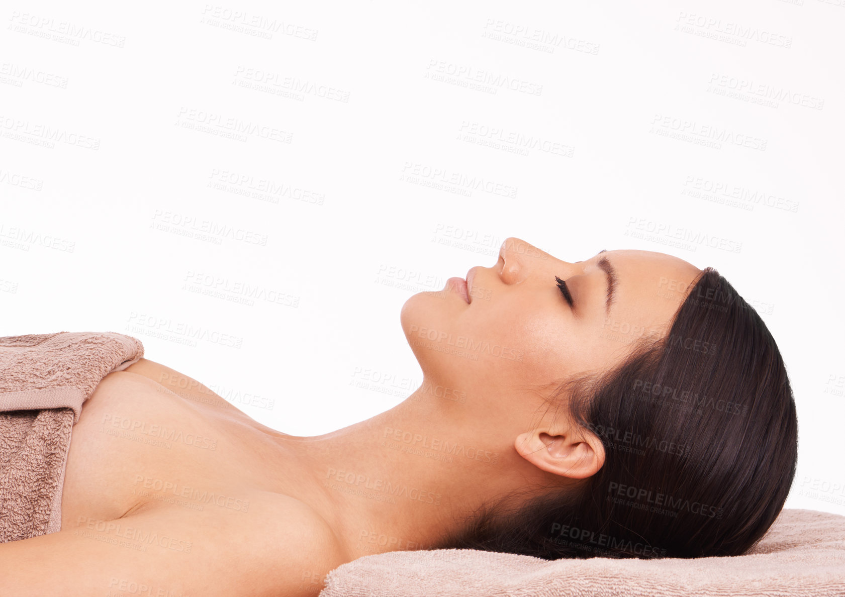 Buy stock photo A beautiful young woman relaxing on a massage table before her massage