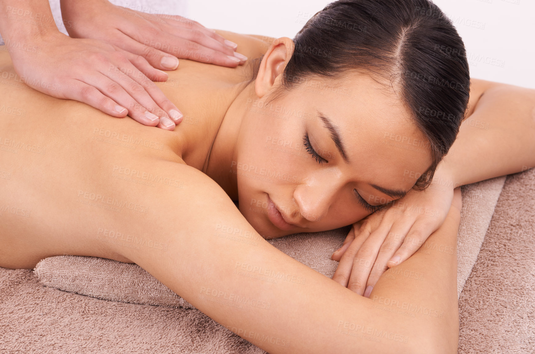 Buy stock photo Hands, zen and woman with back massage at spa for wellness, self care and grooming treatment in studio. Skin, calm and female person with masseuse for body routine on table by white background.