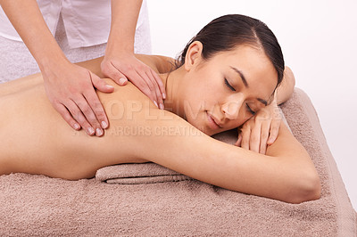 Buy stock photo Hands, wellness and woman with back massage at spa for health, self care and grooming treatment in studio. Skin, calm and female person with masseuse for body routine on table by white background.