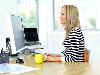 Buy stock photo Shot of a beautiful young woman working at her office desk