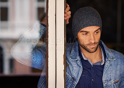 Buy stock photo Man, window and thinking with fashion for dream, vision or memory in wonder or thought at home. Handsome male person or hipster looking out glass frame with beanie or denim clothing at the house