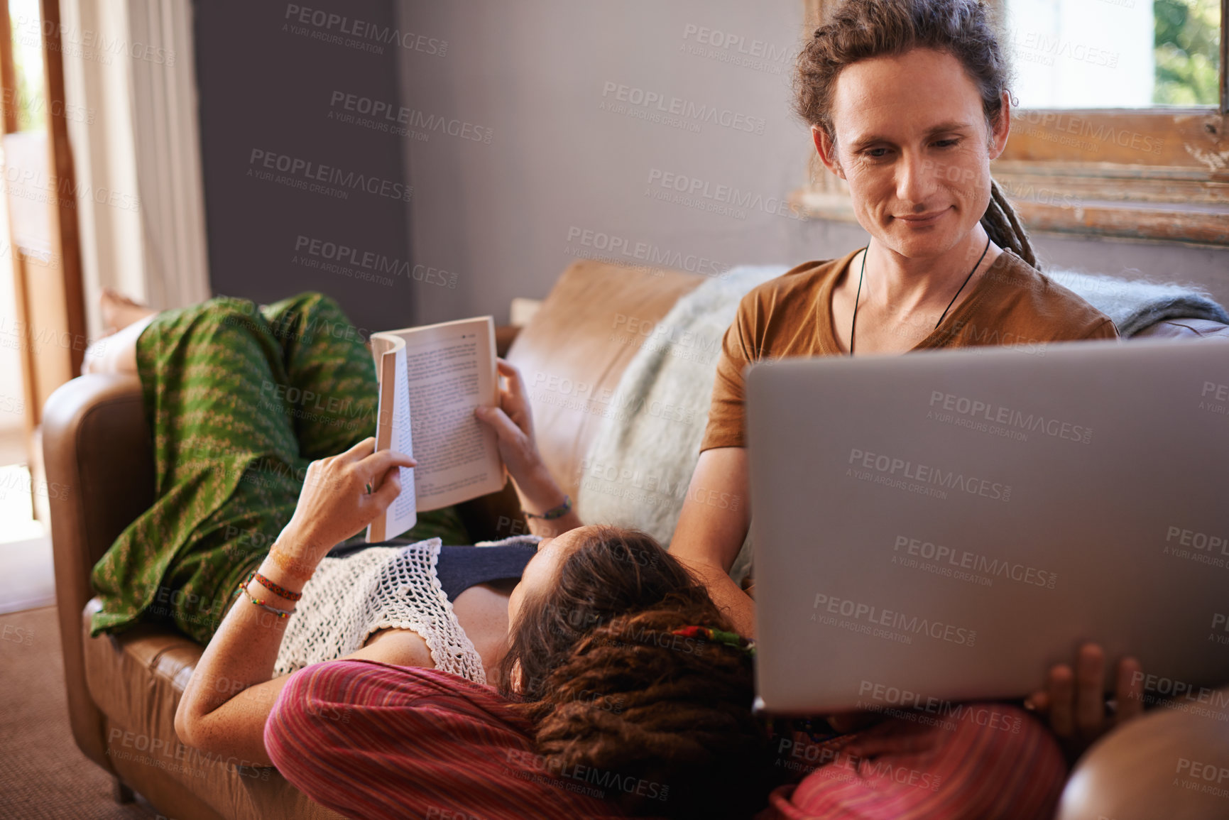 Buy stock photo Relax, book and laptop for happy couple, couch and living room in home. Technology, computer and reading or learning on weekend or vacation, house or lounge or partner together for bonding on holiday