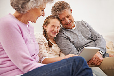 Buy stock photo Tablet, grandma and grandpa with girl in house, senior and woman babysitting granddaughter. Living room, old man and female person with internet for growth and development of child with movies