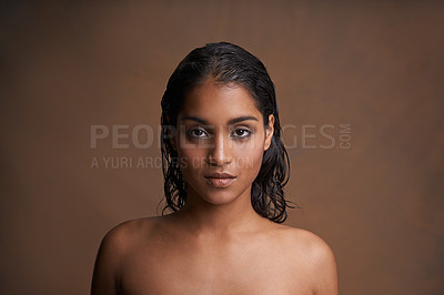 Buy stock photo Studio shot of a beautiful young woman against a brown background