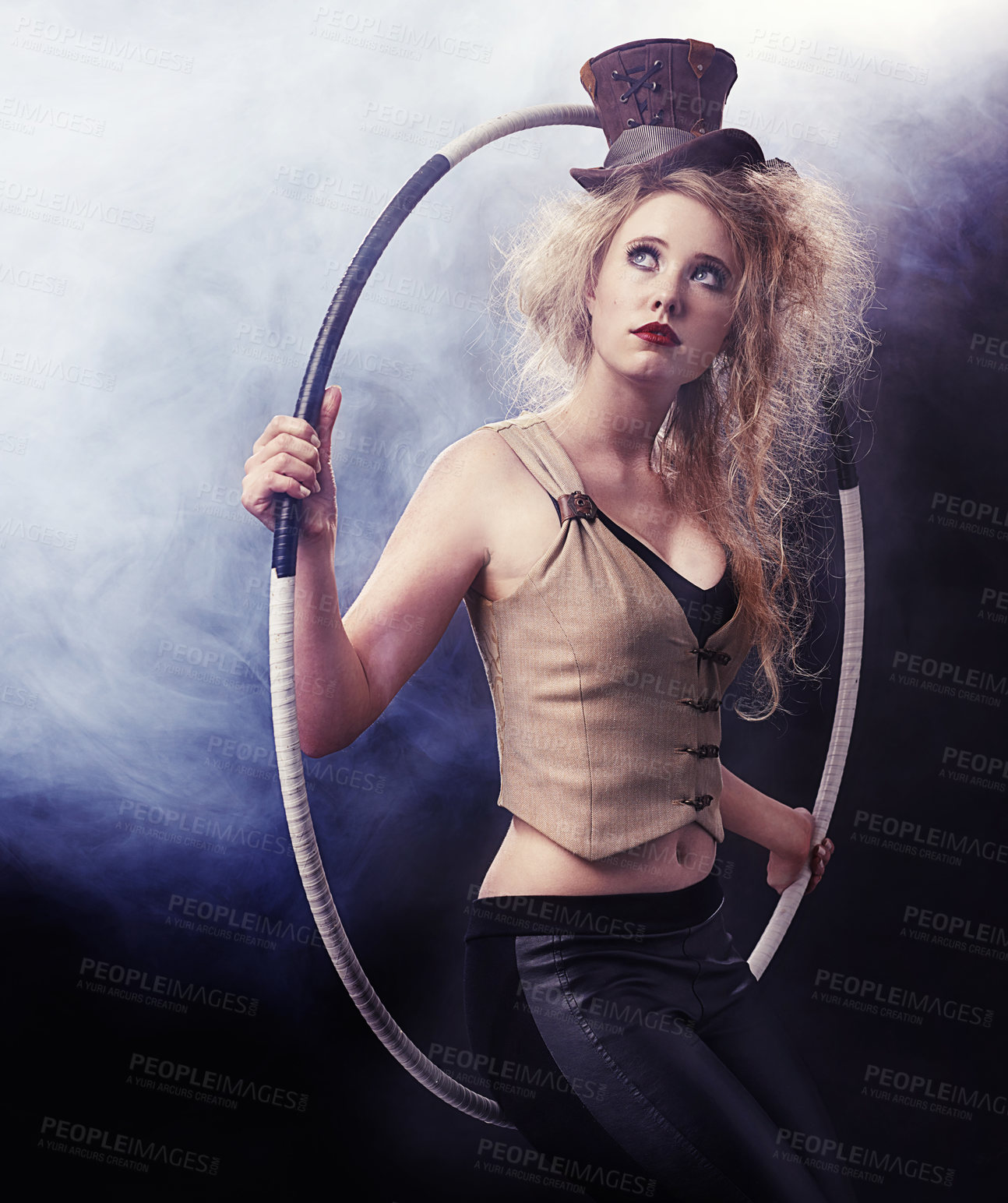 Buy stock photo Woman, hula hoop and carnival for performer and cosplay with costume and smoke for creative and drama on dark background. Young person and thinking for dramatic, circus performance and show indoor