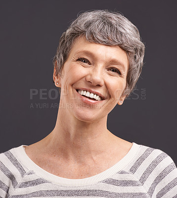Buy stock photo Portrait, happiness and elderly woman with retirement, joyful and casual outfit on a grey studio background. Face, pensioner and old person with mockup space and cheerful with trendy clothes or smile