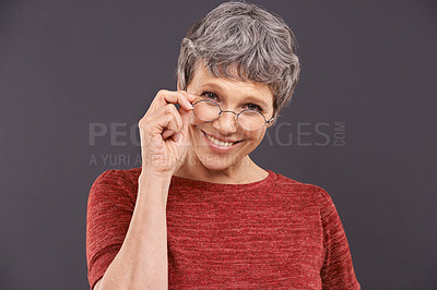 Buy stock photo Happy, portrait and senior woman with glasses in studio for vision, optometry or frame sale on grey background. Eye care, testing or face of old lady model smile for pensioner, spectacles or discount
