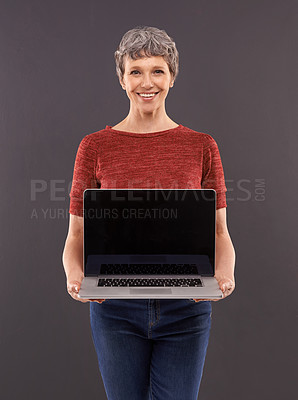 Buy stock photo Elderly, woman and laptop screen in studio with smile, technology and online search or typing and internet connection. Information, browse or social network, senior female person on mockup background