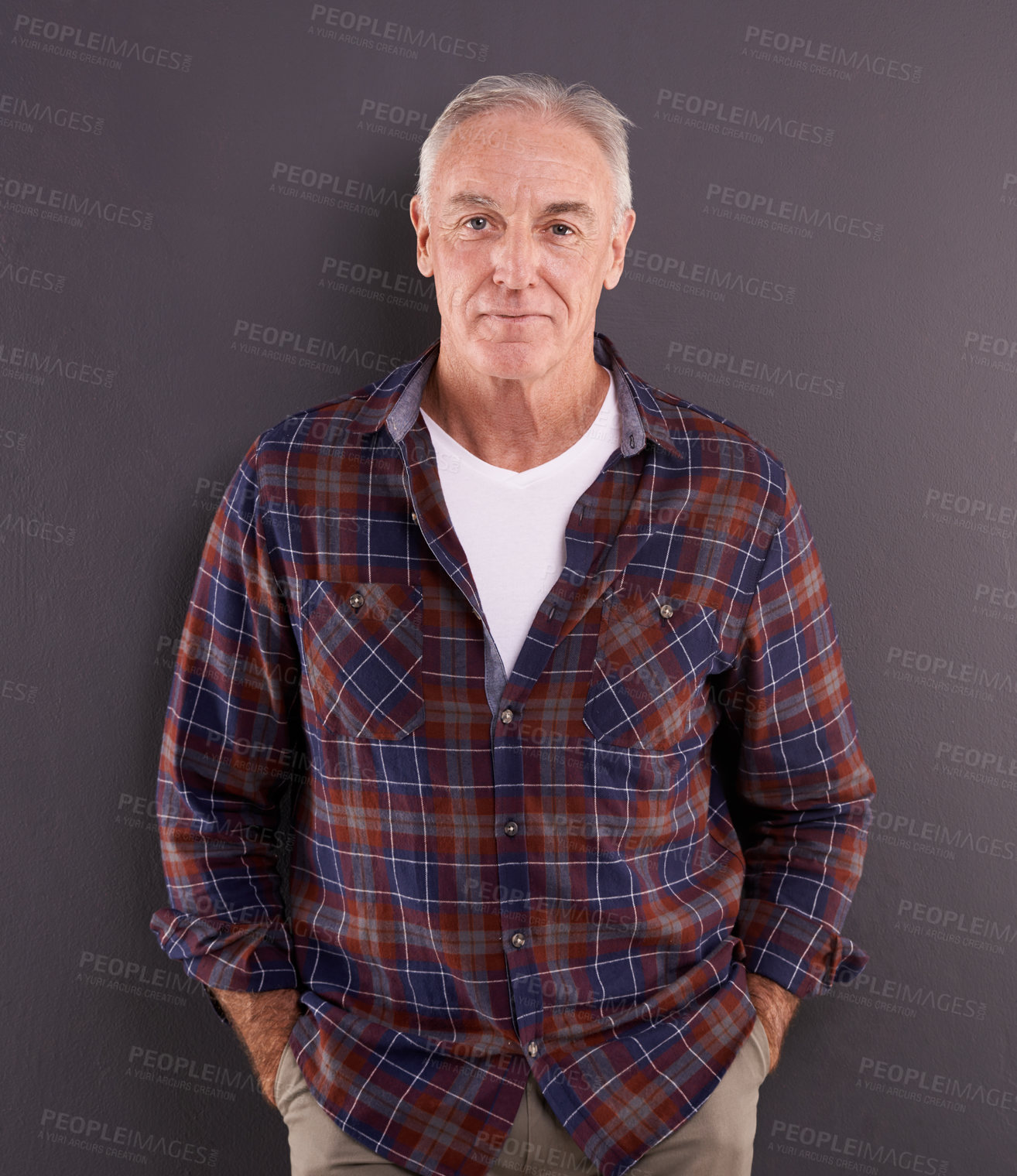 Buy stock photo Studio portrait of an elderly man against a gray background