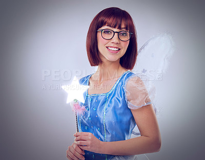 Buy stock photo Studio, portrait and woman as fairy for magic, happiness and looking at wand for fantasy in background. Adult, female person and girl with butterfly wings, dress and model with joy and mystical
