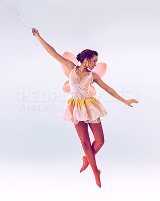 Buy stock photo Woman, fairy and dancer for wand in studio for fantasy, flight and balance with moving by white background. Person, jump and girl for magic, ballet and butterfly wings for steps, art and creativity