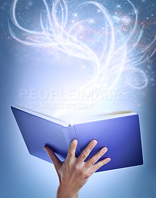 Buy stock photo Hand, person and magic with book, fantasy and sparkle with education on a blue studio background. Model, closeup and reader with literature and knowledge with learning and creativity with glitter