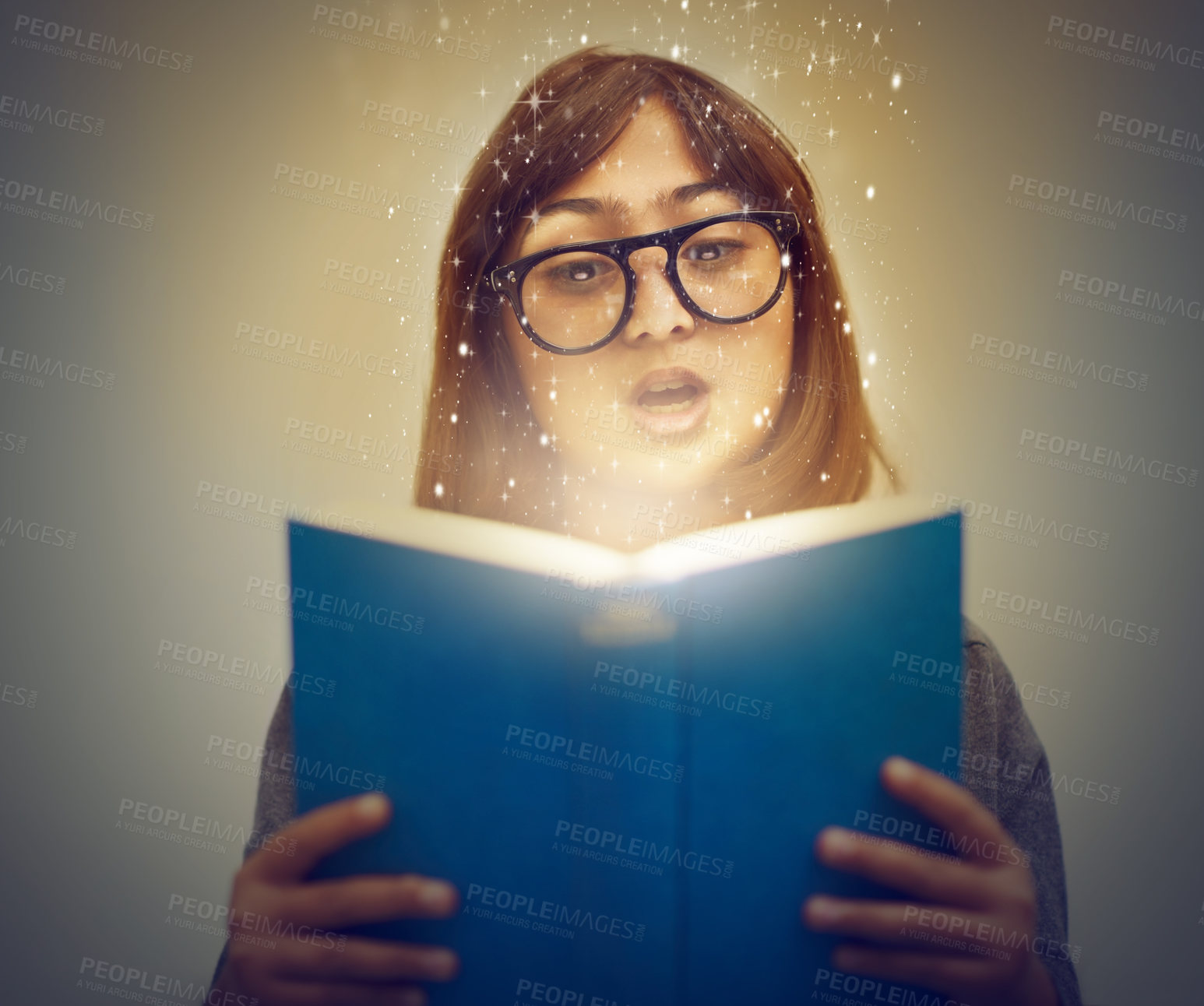 Buy stock photo Glowing pages, book and woman with a story, reading and education on grey studio background. Person, model and girl with a novel and literature with knowledge and creativity with fantasy or astrology