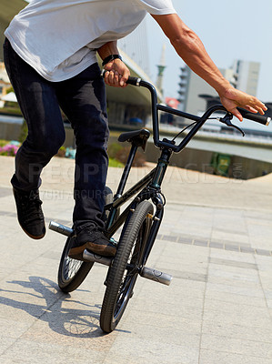Buy stock photo Bike, trick and closeup of man outdoor for sports, balance and action at urban skatepark. Male person, bicycle stunt and control on cycling wheels in city for skill, performance and freedom of motion