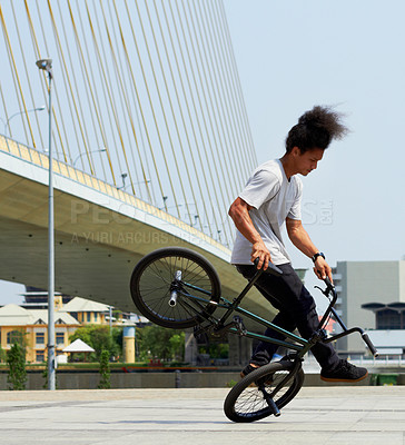 Buy stock photo Boy, action and city with bicycle with trick or training with concrete for transportation. Cycling, outdoor and bmx with male hipster for fun and hobby with bridge and action for balance with stunt.