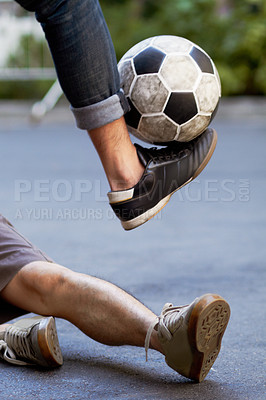 Buy stock photo Street soccer, fitness and legs of people with a ball for sports, training or cardio. Shoes, sport and feet of men playing football in the road for a workout, exercise or action together for a game